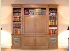 Stained pine bookcase with double doors concealing plasma TV